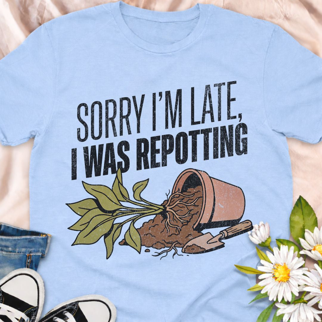 Sorry I’m late, I was repotting. The perfect funny plant lover shirt for anyone obsessed with houseplants and gardening. Featuring a charming repotting graphic design, this soft unisex tee makes a great gift for plant parents, indoor gardeners, and plant addicts.
