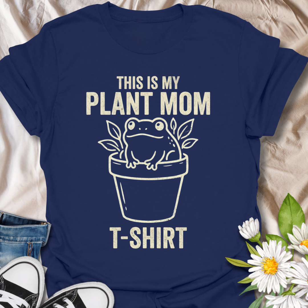 Funny plant mom t-shirt featuring a cute frog sitting in a flower pot with leafy botanical details. A playful plant lover tee for houseplant fans, indoor gardeners, and anyone proud of their plant mom era.