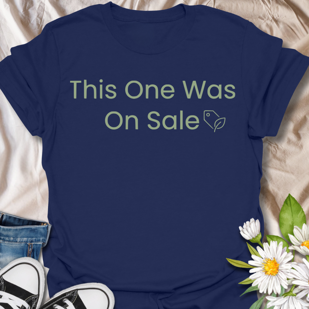 Funny plant lover t-shirt featuring the phrase “This One Was On Sale” with a simple botanical tag icon. A relatable houseplant tee for plant parents, indoor plant fans, and anyone who always makes room for one more plant.