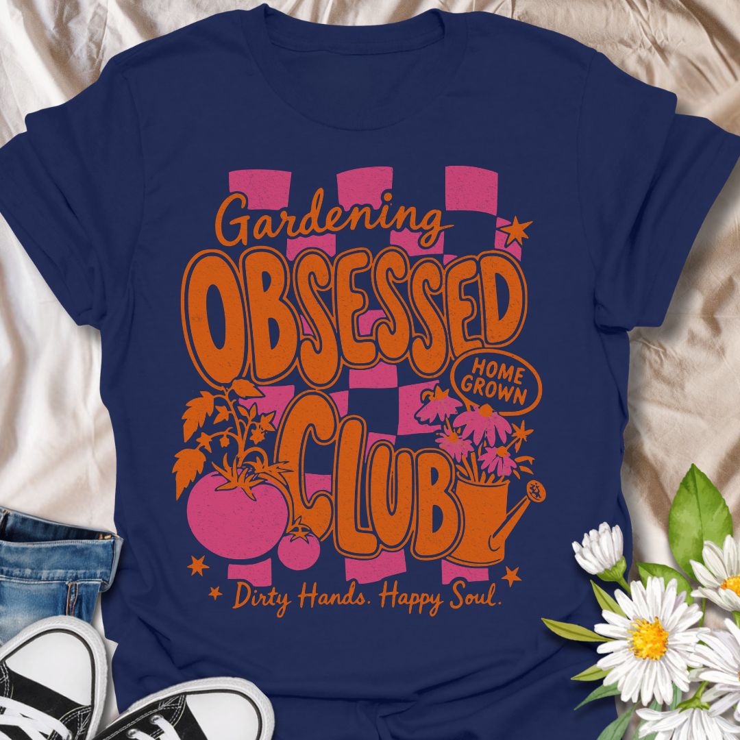 This Gardening Obsessed Club t-shirt is made for gardeners who know dirty hands, homegrown plants, and a happy soul go together perfectly. Featuring bold retro orange lettering, pink checkerboard accents, tomatoes, flowers, a watering can, and playful garden details, this design has a bright vintage-inspired feel full of personality. Perfect for gardeners, plant lovers, vegetable growers, flower fans, cottagecore style lovers, and anyone proudly part of the gardening obsessed club.