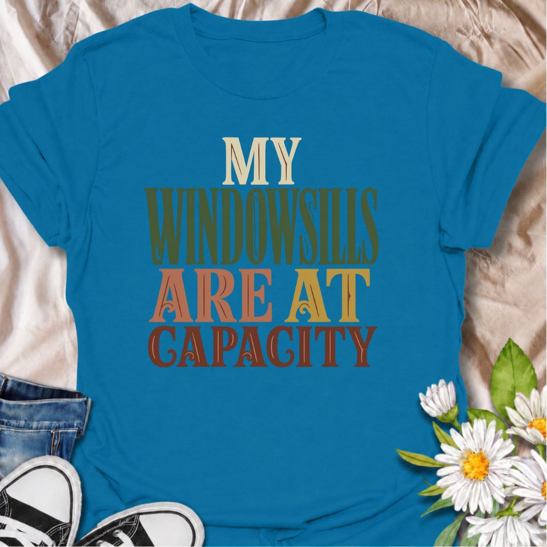 A funny plant T-shirt for anyone whose best windowsills are already completely claimed by houseplants. The phrase “My Windowsills Are at Capacity” is perfect for plant parents, indoor gardeners, and collectors who keep finding room for one more pot anyway. Its bold retro typography makes the design easy to read while keeping it simple and wearable. It makes a great gift for pothos lovers, houseplant collectors, and anyone with an ever-growing indoor jungle. Ideal for nursery trips, plant swaps, garden cente