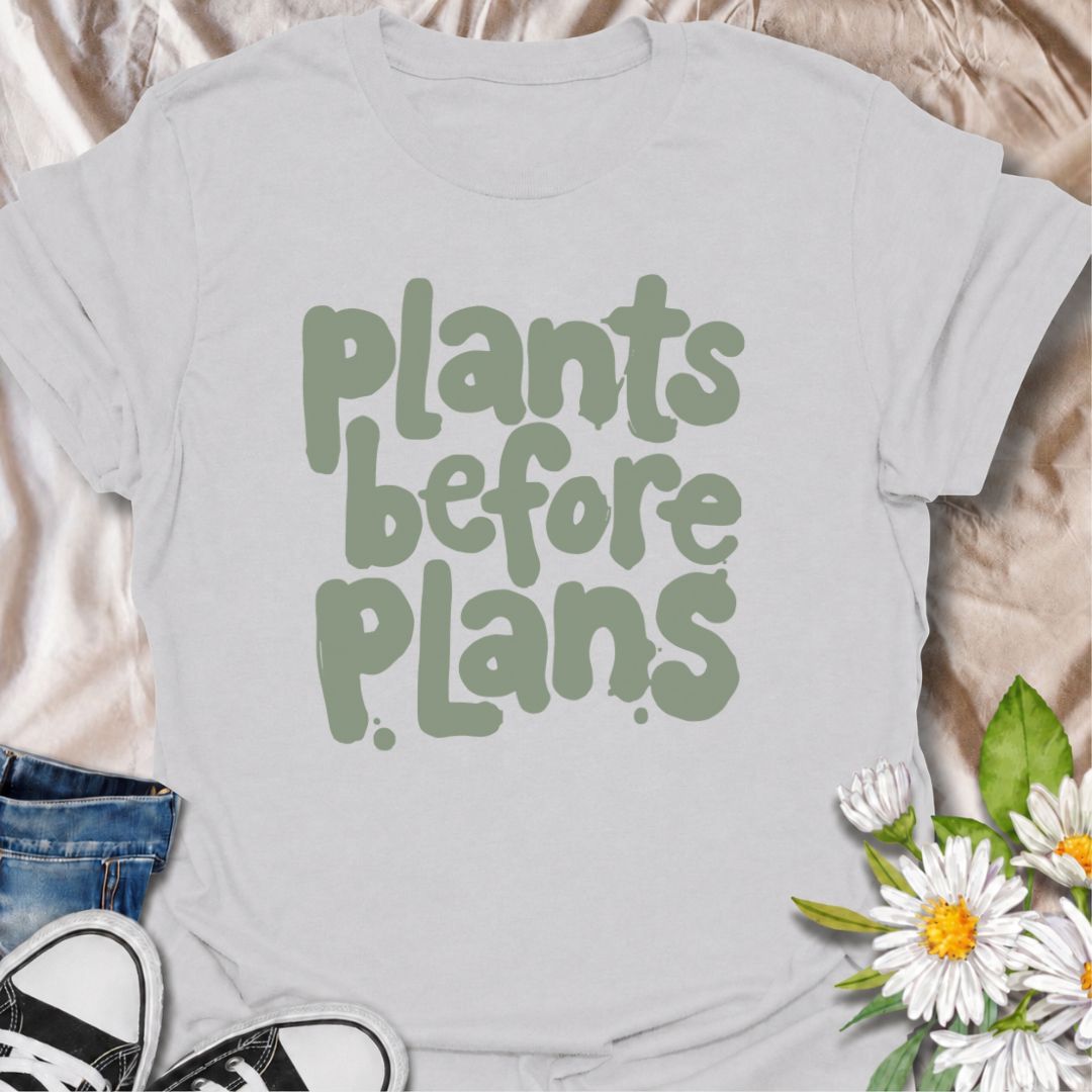 A funny plant T-shirt for anyone whose priorities are clear: plants first, plans later. The phrase “Plants Before Plans” is simple, playful, and instantly relatable for houseplant lovers, plant parents, and indoor gardeners. Its chunky retro typography gives the design a casual, modern feel that is easy to wear. It makes a great gift for plant collectors, nursery regulars, and anyone who would happily cancel plans for a quiet day with their plants. Perfect for plant shopping, greenhouse visits, relaxed week