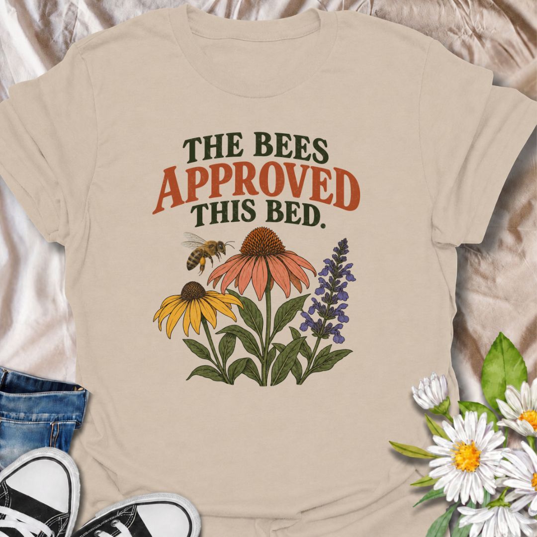 A cheerful gardening T-shirt for anyone who takes pride in growing flowers the pollinators love. The phrase “The Bees Approved This Bed” pairs perfectly with coneflowers, black-eyed Susans, salvia, and a visiting bee for a garden design with real pollinator appeal. It is ideal for flower gardeners, wildlife gardeners, native plant lovers, and anyone creating a bee-friendly backyard. The design makes a lovely gift for gardeners who enjoy supporting bees while filling their beds with color. Perfect for garden