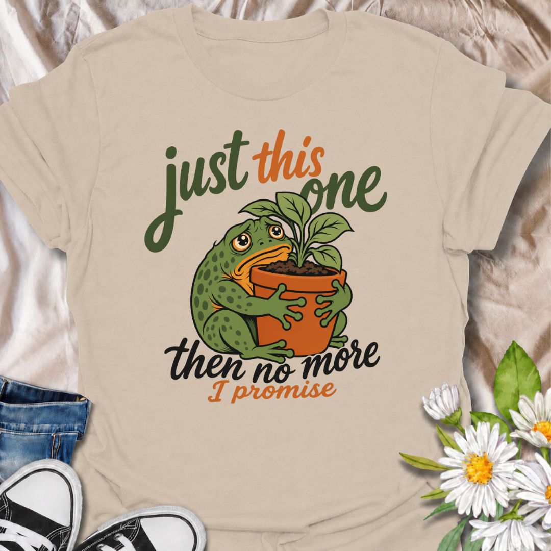 A funny plant T-shirt for anyone who swears every new purchase really will be the last one. The phrase “Just This One, Then No More. I Promise.” pairs with a wide-eyed frog hugging a potted plant for playful, instantly relatable plant-parent humor. It is perfect for houseplant lovers, plant collectors, nursery regulars, and anyone who can never quite resist one more plant. The character-led artwork gives the design plenty of personality while keeping the joke clear and easy to wear. A great gift for plant l