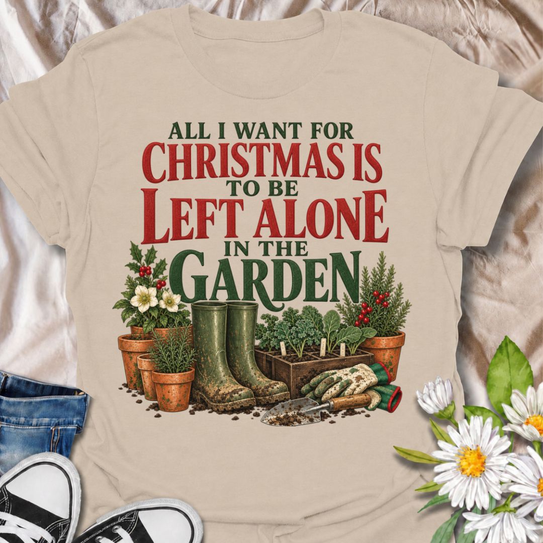 A funny Christmas gardening T-shirt for anyone whose perfect holiday involves escaping outside and being left alone with the plants. The phrase “All I Want for Christmas Is to Be Left Alone in the Garden” pairs with muddy wellies, gloves, a hand trowel, herbs, and festive holly for a design made especially for real gardeners. It is perfect for backyard gardeners, flower growers, vegetable gardeners, and anyone who would rather spend Christmas pottering outside than making small talk indoors. The vintage-sty