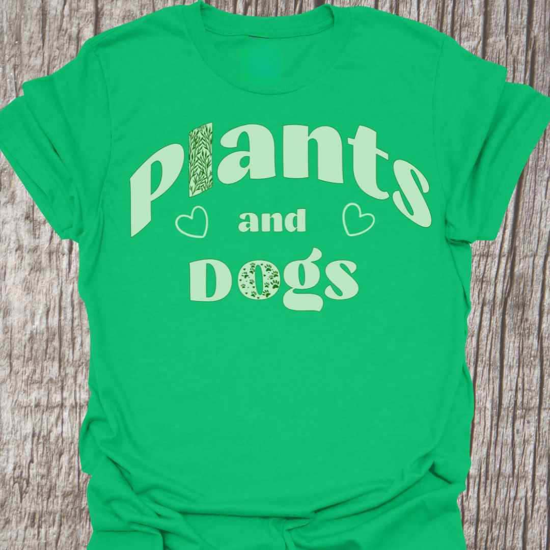 Plants and Dogs in text with subtle paw prints and leaves within the text design, decorated with two small hearts. Light green on an Irish green t-shirt