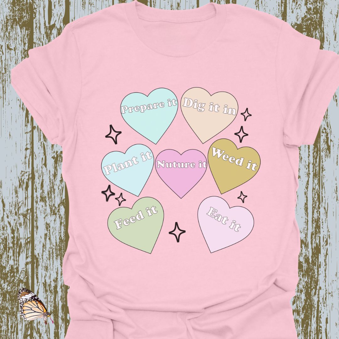 Hearts with plant-related text in pastel colors on a light pink T-shirt