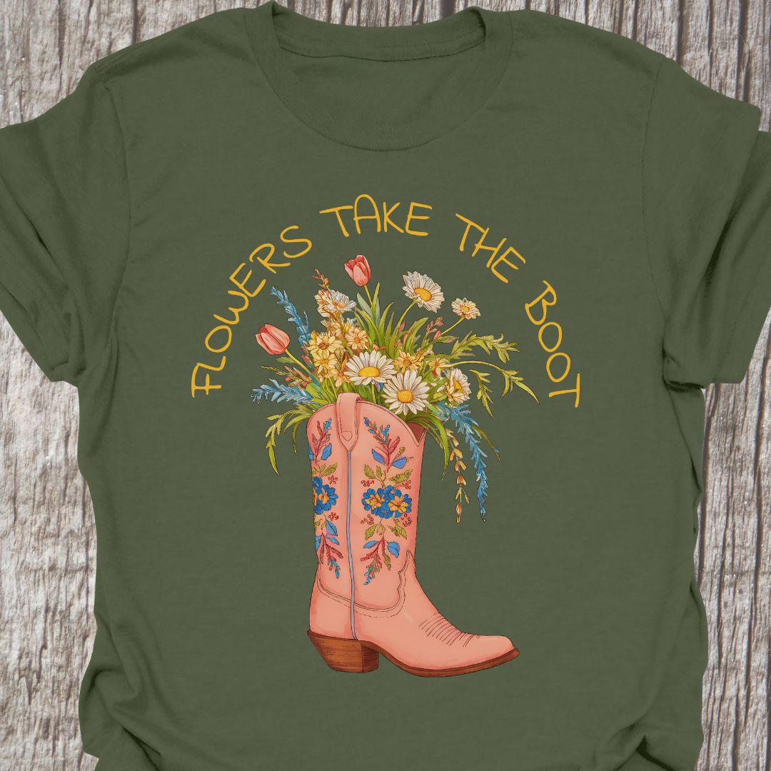 Flowers Take The Boot - Military green t-shirt featuring a pink boot with flowers emerging from it. The boot also has a floral design.