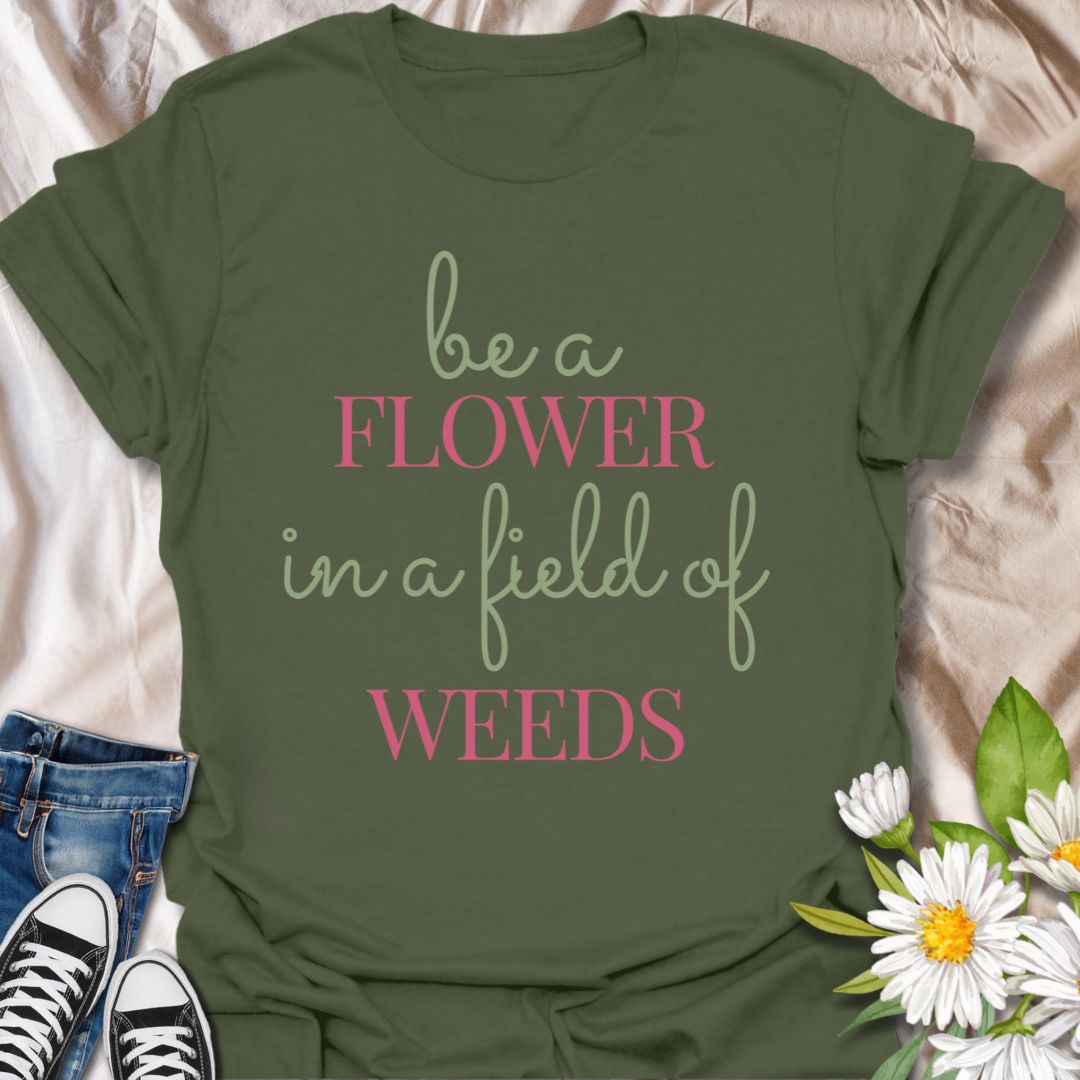 Stand out with this inspirational graphic t-shirt featuring the motivational phrase "Be a Flower in a Field of Weeds." Perfect for positivity seekers, nature lovers, and anyone who enjoys uplifting, floral-themed apparel with a meaningful message.