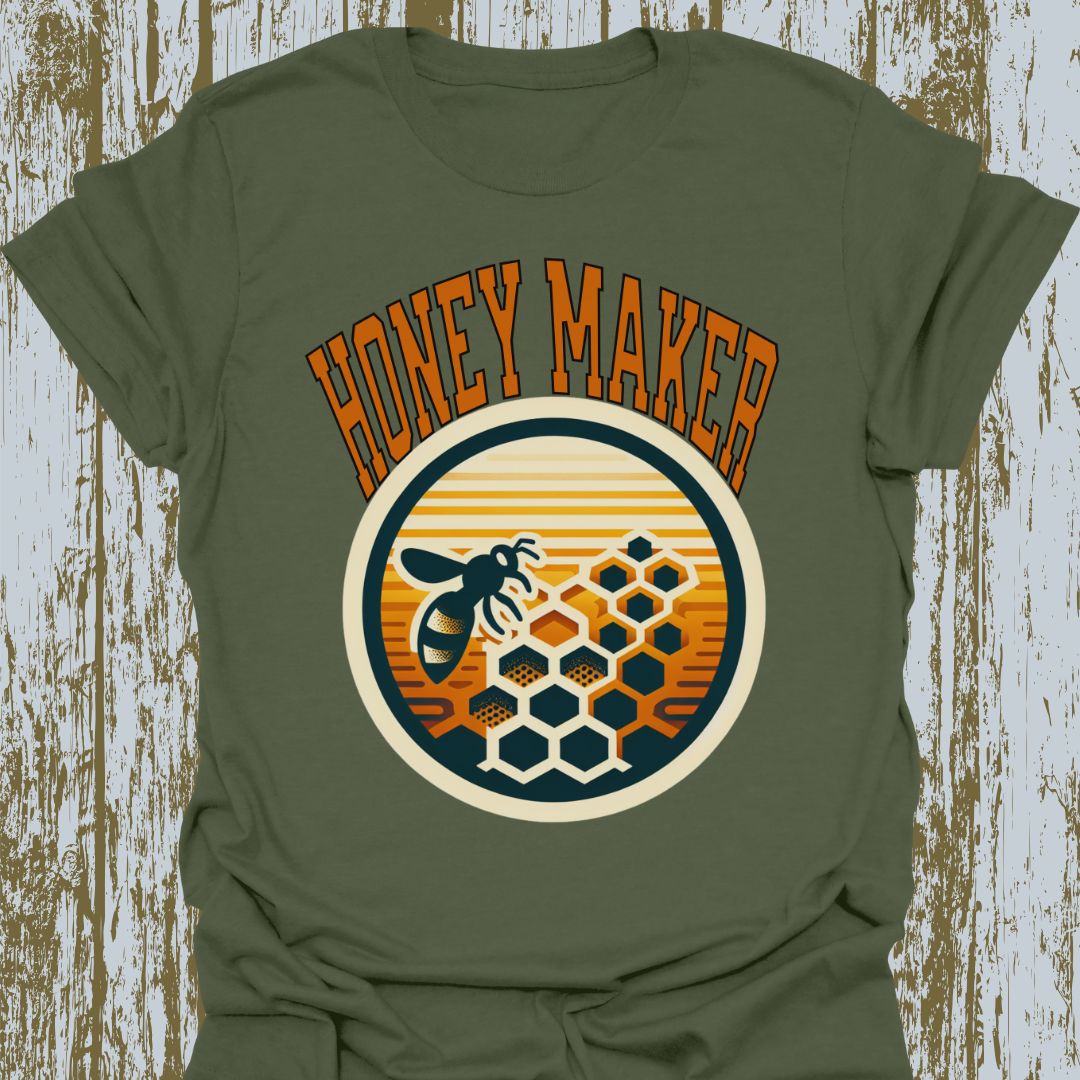 Military Green T-shirt featuring a circular design with a bee and honeycomb, accompanied by the text "Honey Maker" in orange.
