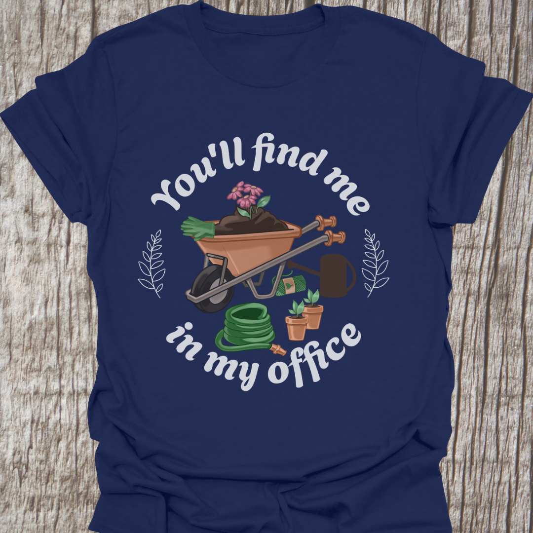 circular text 'You'll find me in my office' with wheelbarrow, hose, plants and watering can within circle all text in white on navy blue t-shirt