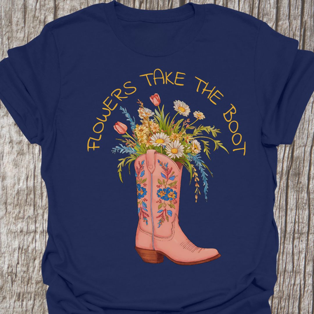 Flowers Take The Boot - Navy blue t-shirt featuring a pink boot with flowers emerging from it. The boot also has a floral design.