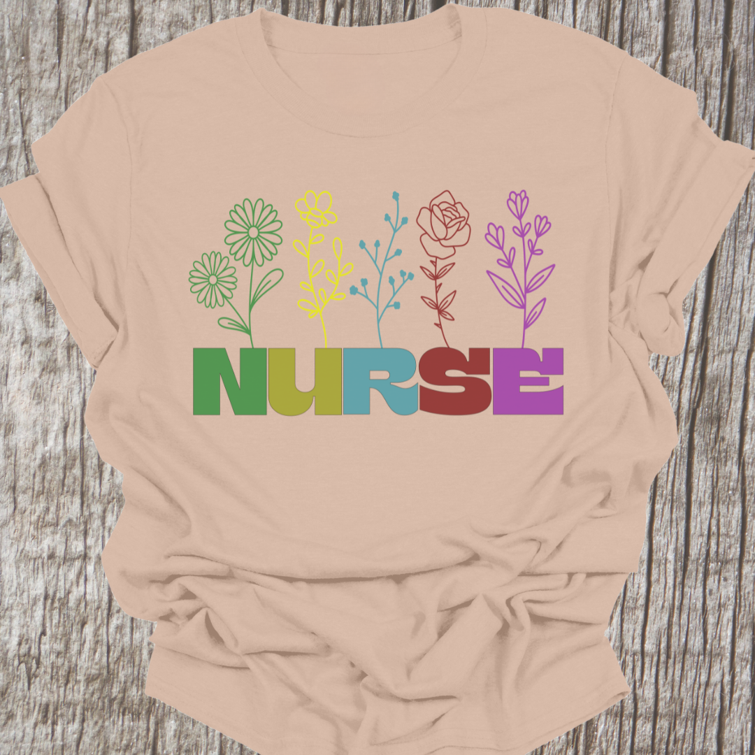 Beautiful Nurse t-shirt with the word NURSE each letter being a different color, with a flower attached to the letter in same color, on a sand t-shirt