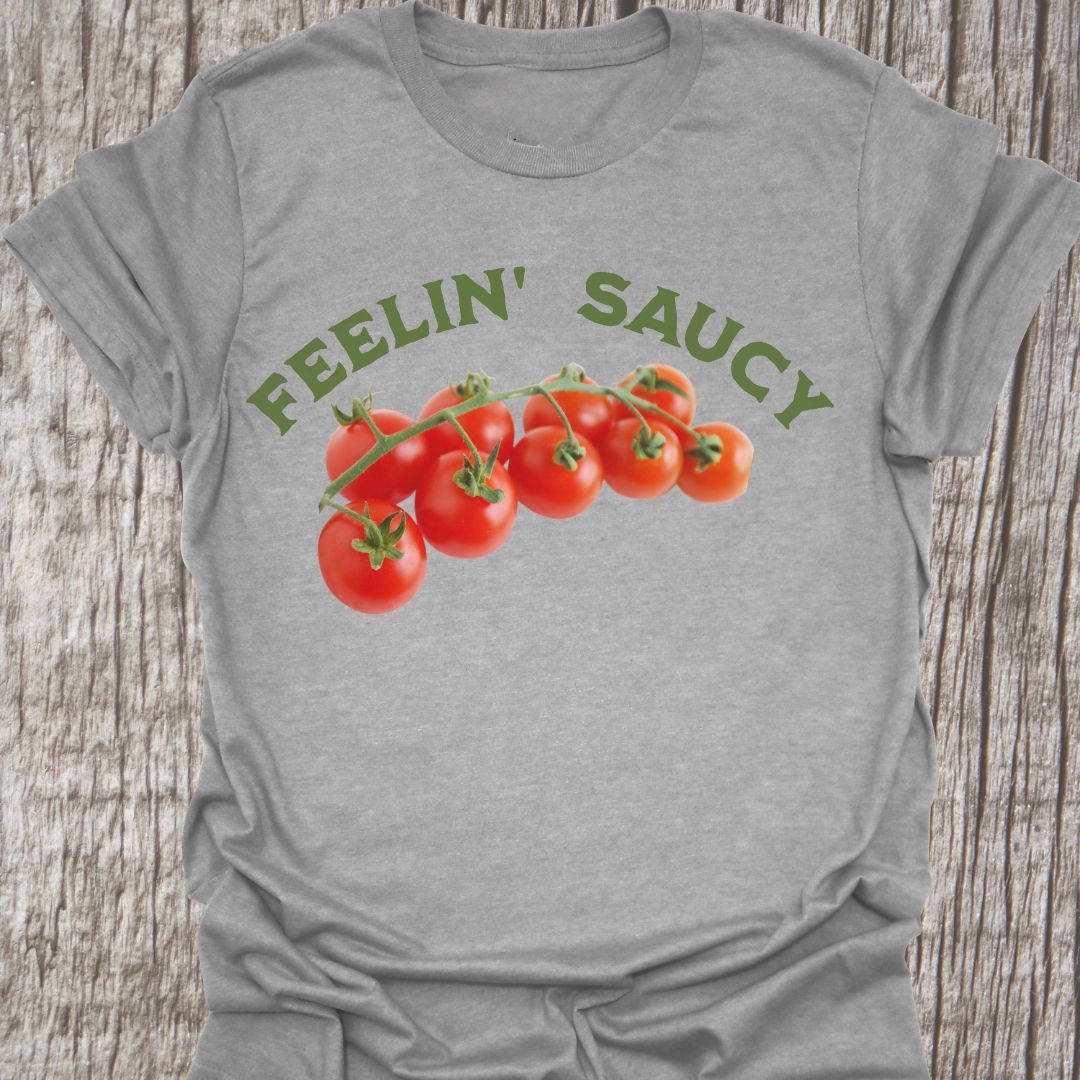 Feelin' Saucy Text written in an arch over image of tomatoes on the vine on a sport grey t-shirt