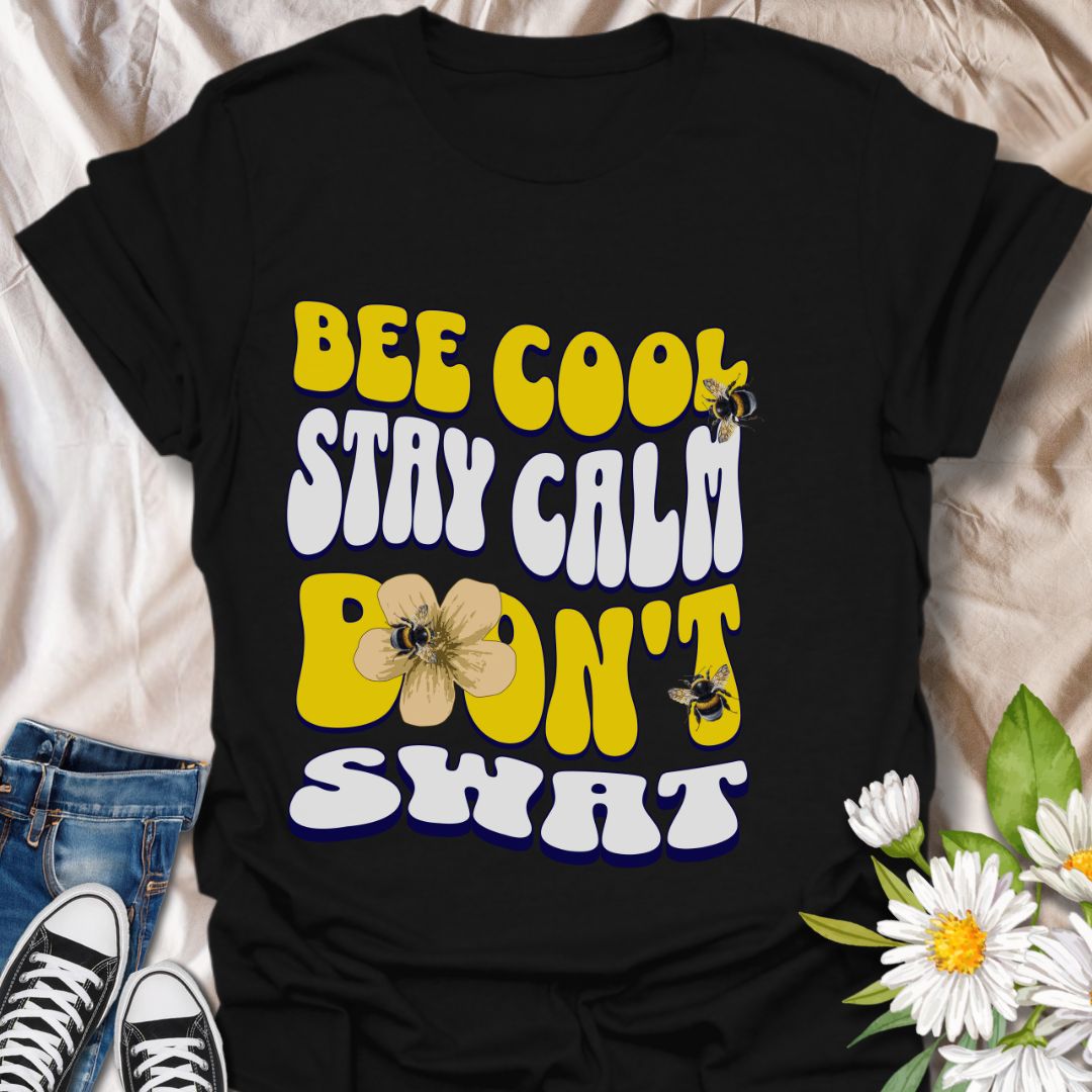 Playful bee-themed t-shirt with "Bee Cool Stay Calm Don't Swat" design. Fun gift for bee lovers, pollinator enthusiasts, and anyone who appreciates a lighthearted garden vibe. Black
