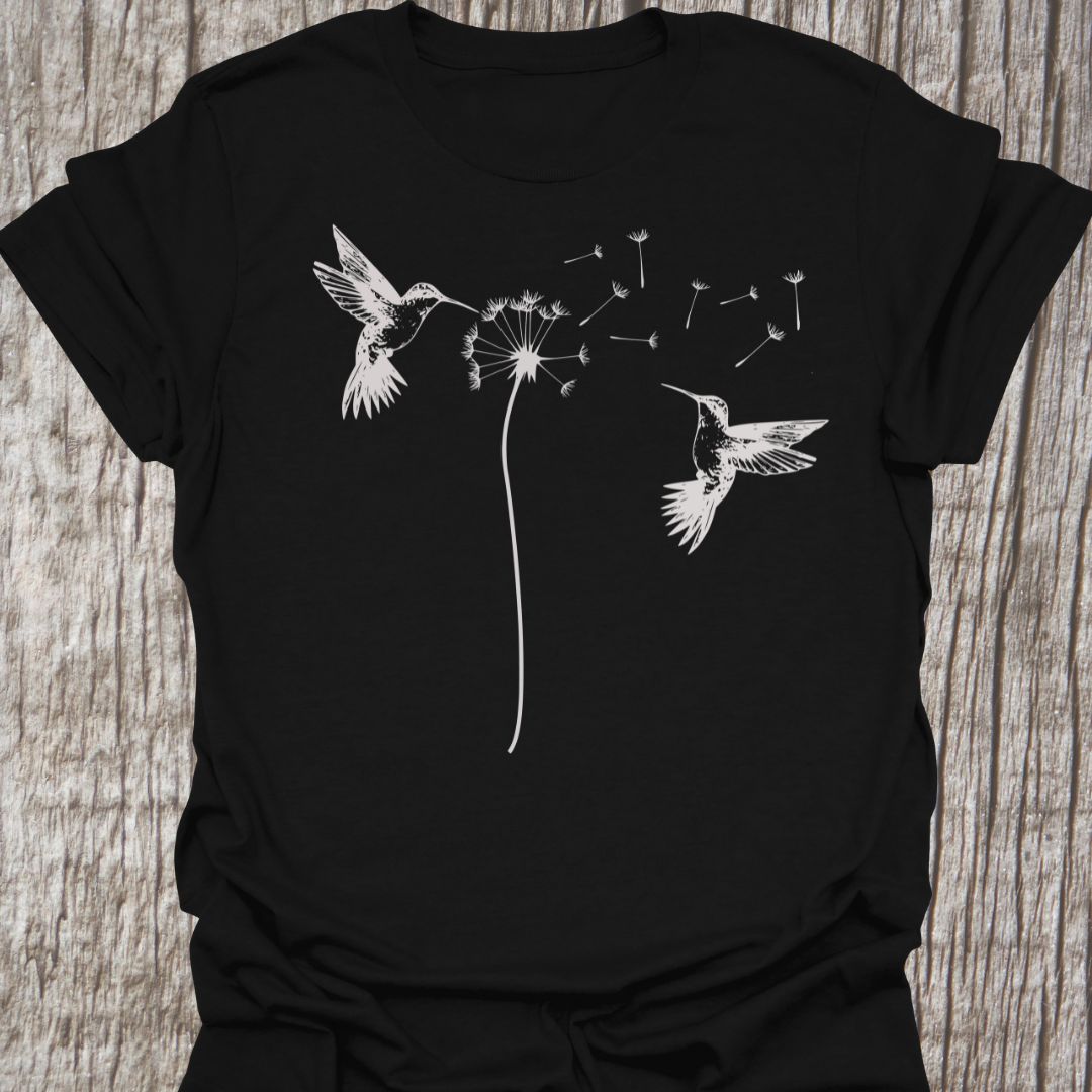 Two humming birds hovering at Dandelion in white on black t-shirt