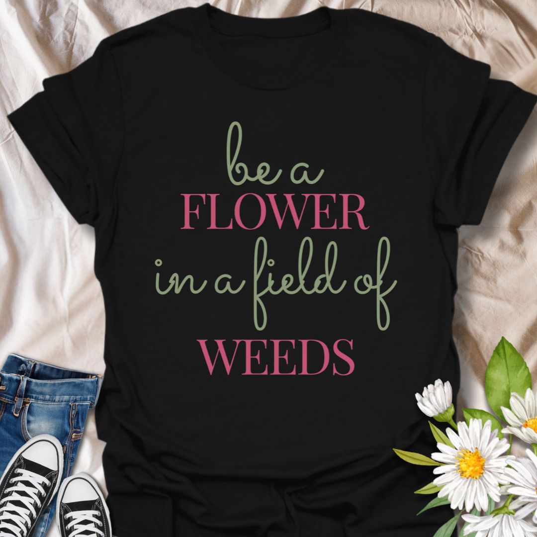 Stand out with this inspirational graphic t-shirt featuring the motivational phrase "Be a Flower in a Field of Weeds." Perfect for positivity seekers, nature lovers, and anyone who enjoys uplifting, floral-themed apparel with a meaningful message.