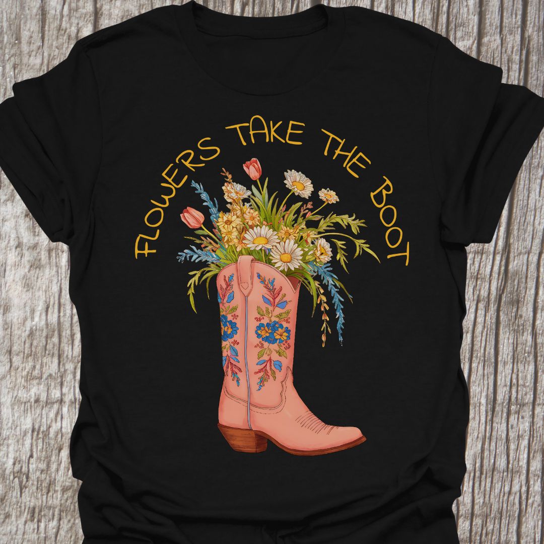 Flowers Take The Boot - Black t-shirt featuring a pink boot with flowers emerging from it. The boot also has a floral design.