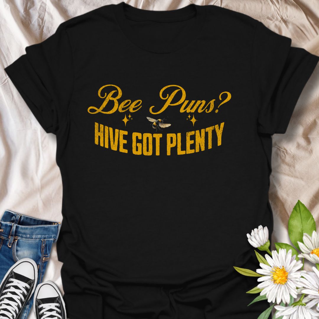 Funny "Bee Puns? Hive Got Plenty" t-shirt with vintage yellow typography and bee illustration on crisp white. Ideal for beekeepers, honey bee lovers, gardeners, pollinator supporters, and anyone who loves a clever bee pun. Great nature lover gift and perfect for eco-friendly fashion.