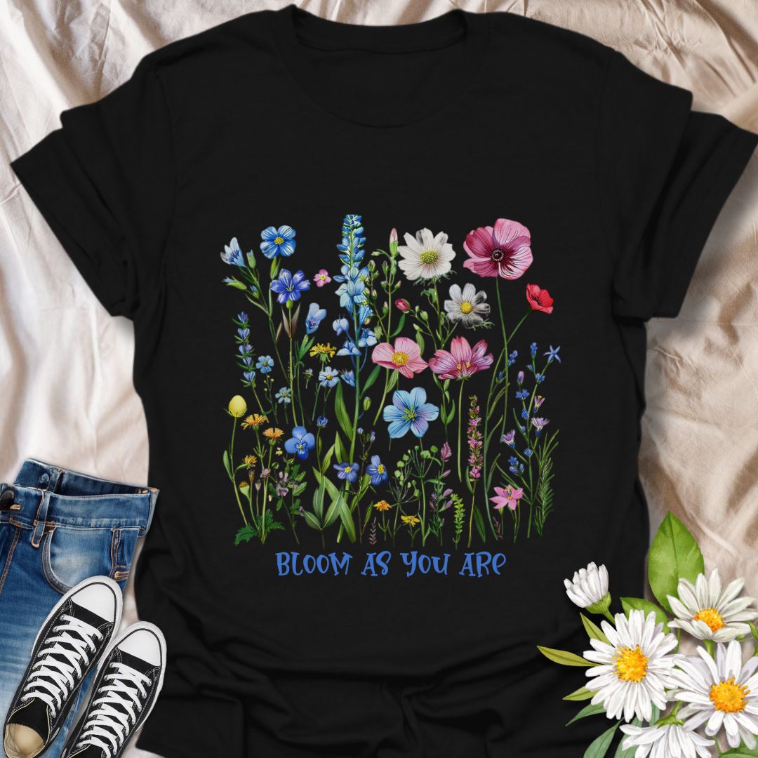 Empowering floral t-shirt featuring a vibrant wildflower garden and the phrase 'Bloom as you are.' A nature-positive, uplifting design for flower lovers, gardeners, and anyone who appreciates self-growth and beauty in every stage. Ideal for gifting or everyday wear with heart
