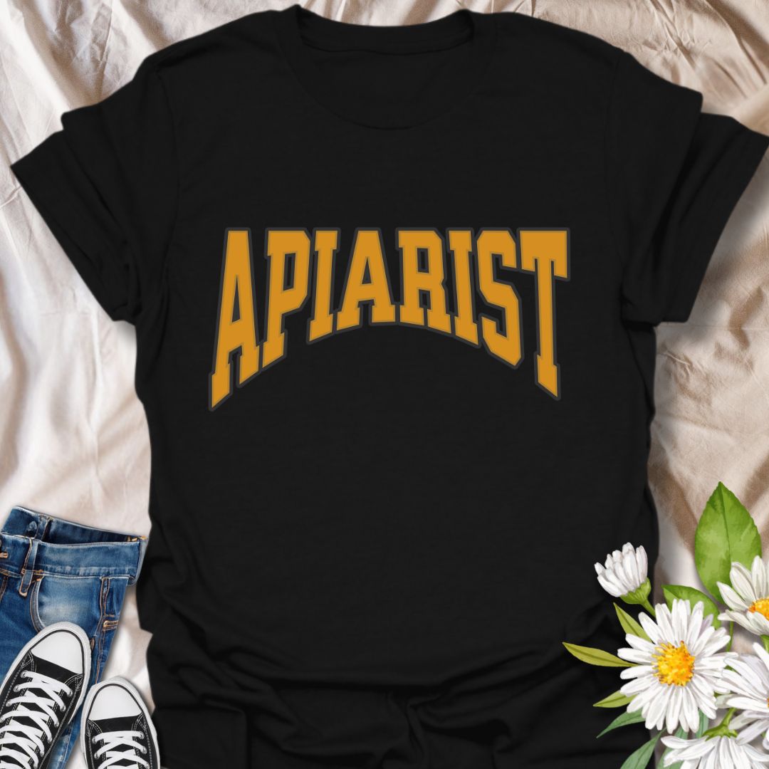 Simple bold "Apiarist" t-shirt with collegiate-style yellow lettering on black. Perfect for professional beekeepers, hobbyist beekeepers, honey producers, and bee conservation advocates. Great gift for anyone passionate about apiculture, bee science, or protecting pollinators.
