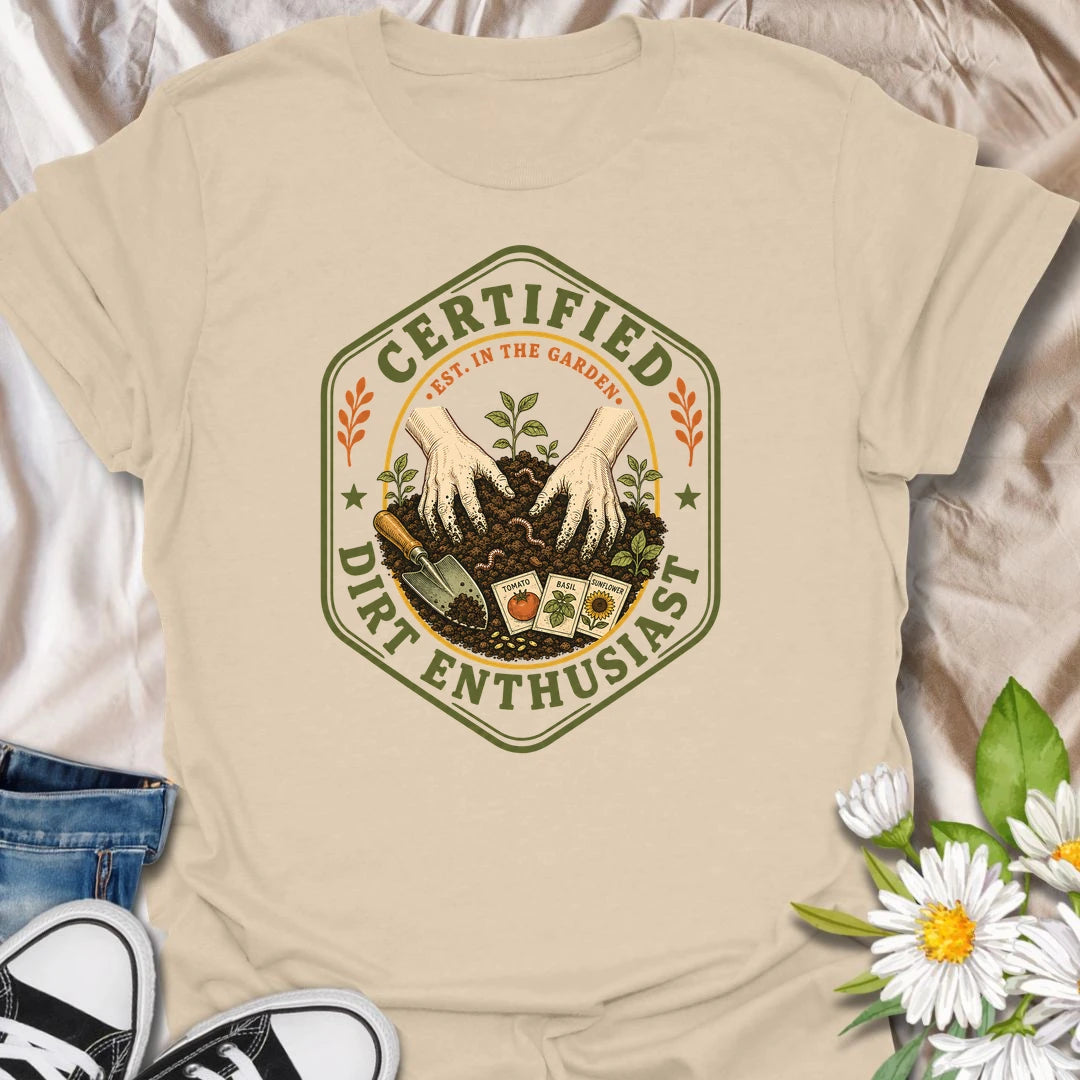 This Certified Dirt Enthusiast t-shirt is made for gardeners who are happiest with their hands in the soil and seedlings ready to grow. Featuring a vintage badge-style design with gloved hands, rich garden dirt, seed packets, tools, and fresh sprouts, this tee has a classic gardening-club feel with plenty of earthy personality. Perfect for gardeners, plant lovers, backyard growers, vegetable gardeners, flower fans, and anyone who proudly loves dirt, seeds, and garden time.
