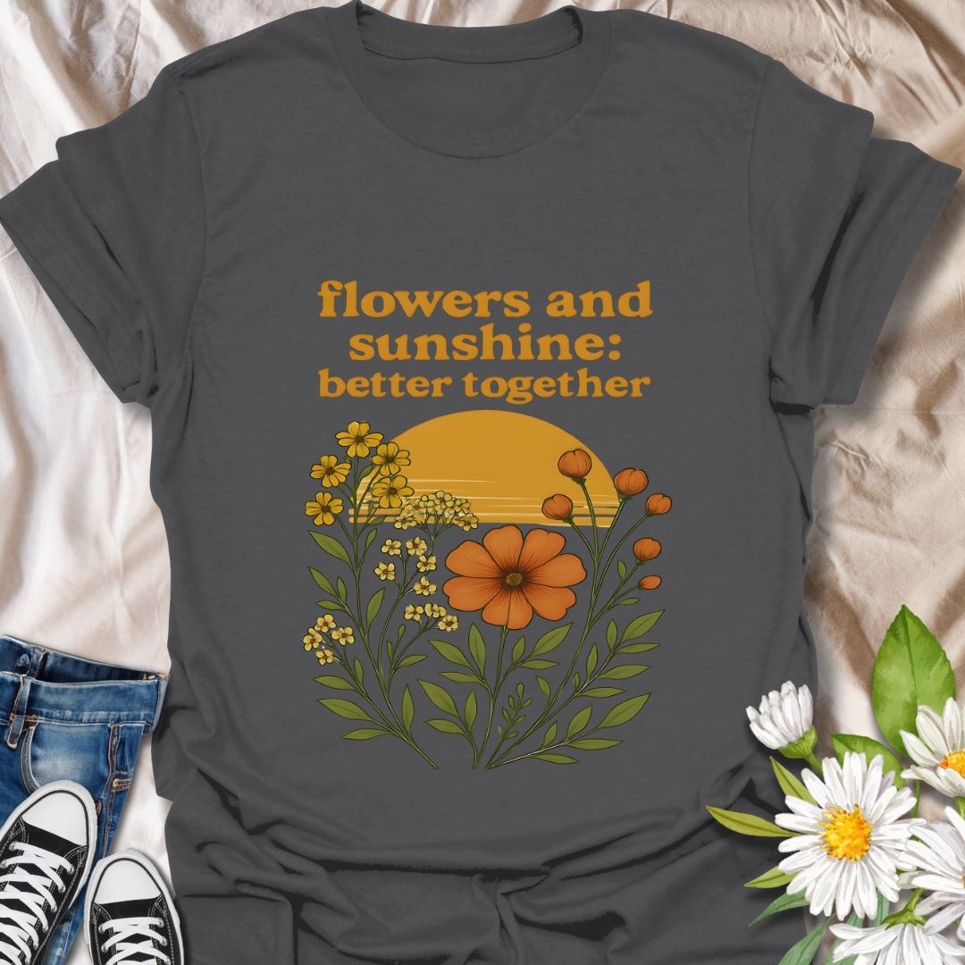 Vintage-inspired floral graphic t-shirt featuring a vibrant sunset and wildflowers. 'Flowers and sunshine: better together' design on soft cornsilk color fabric. Perfect casual wear for nature lovers, flower enthusiasts, and boho style fans. Great gift for outdoor lovers, spring and summer fashion.