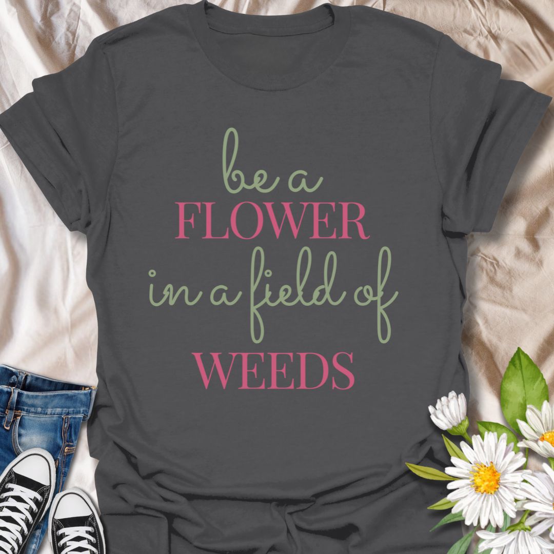 Stand out with this inspirational graphic t-shirt featuring the motivational phrase "Be a Flower in a Field of Weeds." Perfect for positivity seekers, nature lovers, and anyone who enjoys uplifting, floral-themed apparel with a meaningful message.