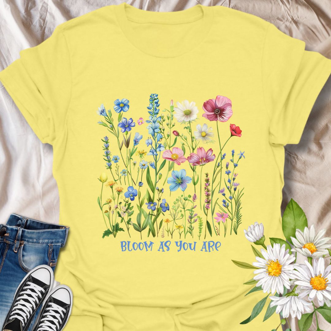Empowering floral t-shirt featuring a vibrant wildflower garden and the phrase 'Bloom as you are.' A nature-positive, uplifting design for flower lovers, gardeners, and anyone who appreciates self-growth and beauty in every stage. Ideal for gifting or everyday wear with heart