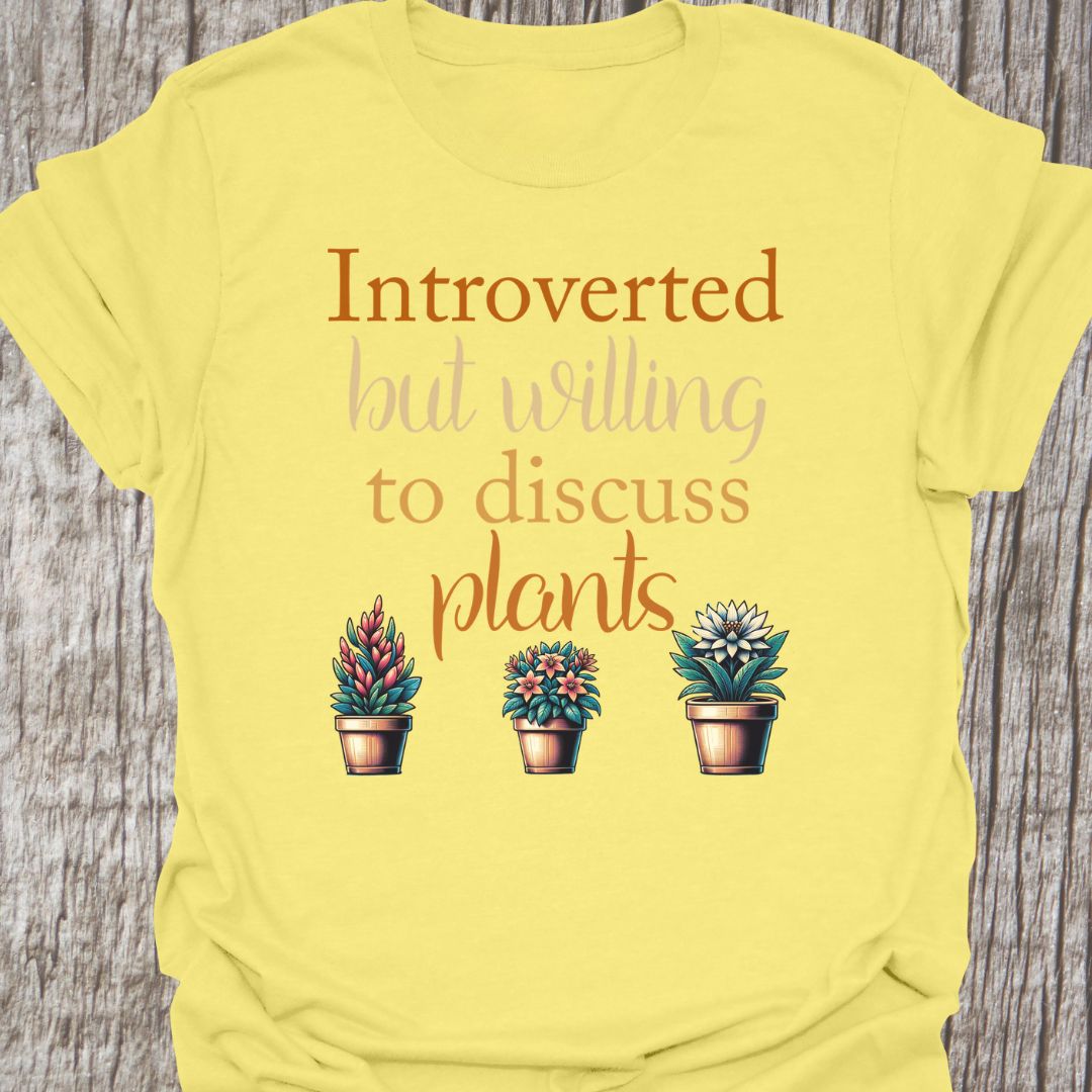 Introverted but willing to discuss plants in natural colored text with image of three flowering pot plants, on a cornsilk t-shirt