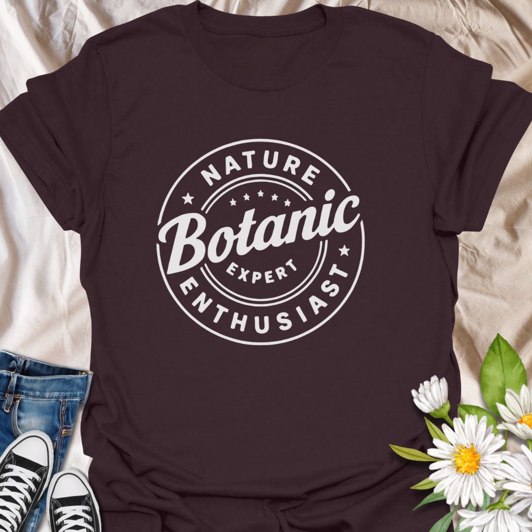 Show off your love for plants with this bold graphic t-shirt featuring the phrase "Nature Expert Botanic Enthusiast." This is in either white or black text, dependant on the color choice. This Tee is Perfect for gardeners, plant parents, and anyone passionate about botany, nature, and green living.