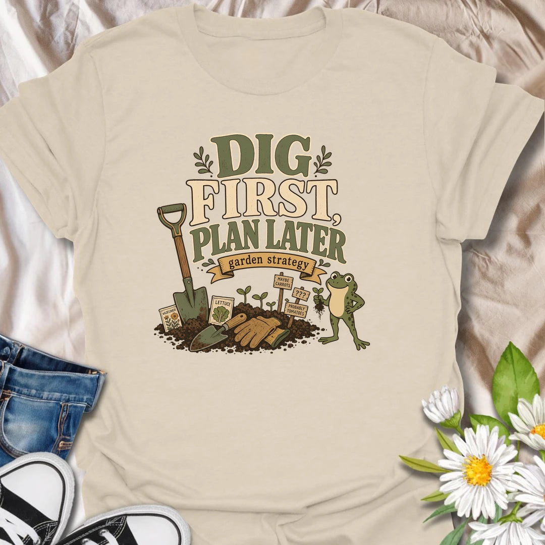A funny gardener T-shirt for anyone whose garden strategy begins with digging and develops from there. The vintage-style design features a frog, shovel, gardening gloves, seedlings, and slightly uncertain plant markers. A playful gift for vegetable gardeners, backyard growers, and spontaneous planting enthusiasts.