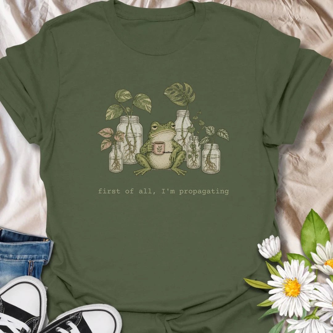 This First Of All, I’m Propagating t-shirt is perfect for plant lovers who are always snipping, rooting, and growing one more cutting. Featuring a relaxed frog holding a mug surrounded by propagation jars and trailing houseplants, this design blends cozy plant humor with a cottagecore botanical feel. Great for plant moms, plant dads, houseplant collectors, frog lovers, and anyone obsessed with propagating pothos, monstera, and indoor plants.