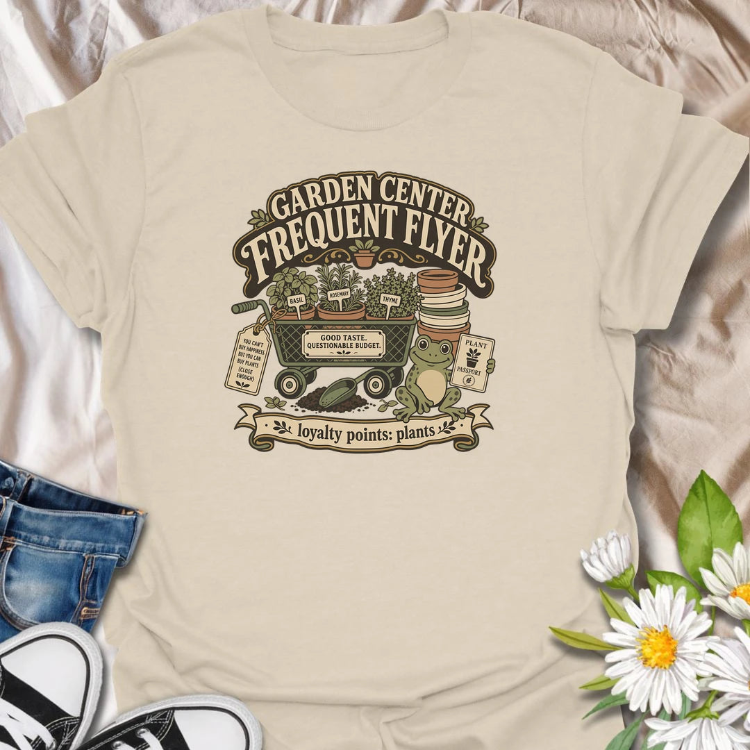 Earn imaginary loyalty points with this funny “Garden Center Frequent Flyer” T-shirt. Featuring a plant-filled cart, herb pots, garden supplies, and a cheerful frog, it is made for anyone who never leaves the nursery empty-handed. A playful gift for plant shoppers and enthusiastic gardeners.