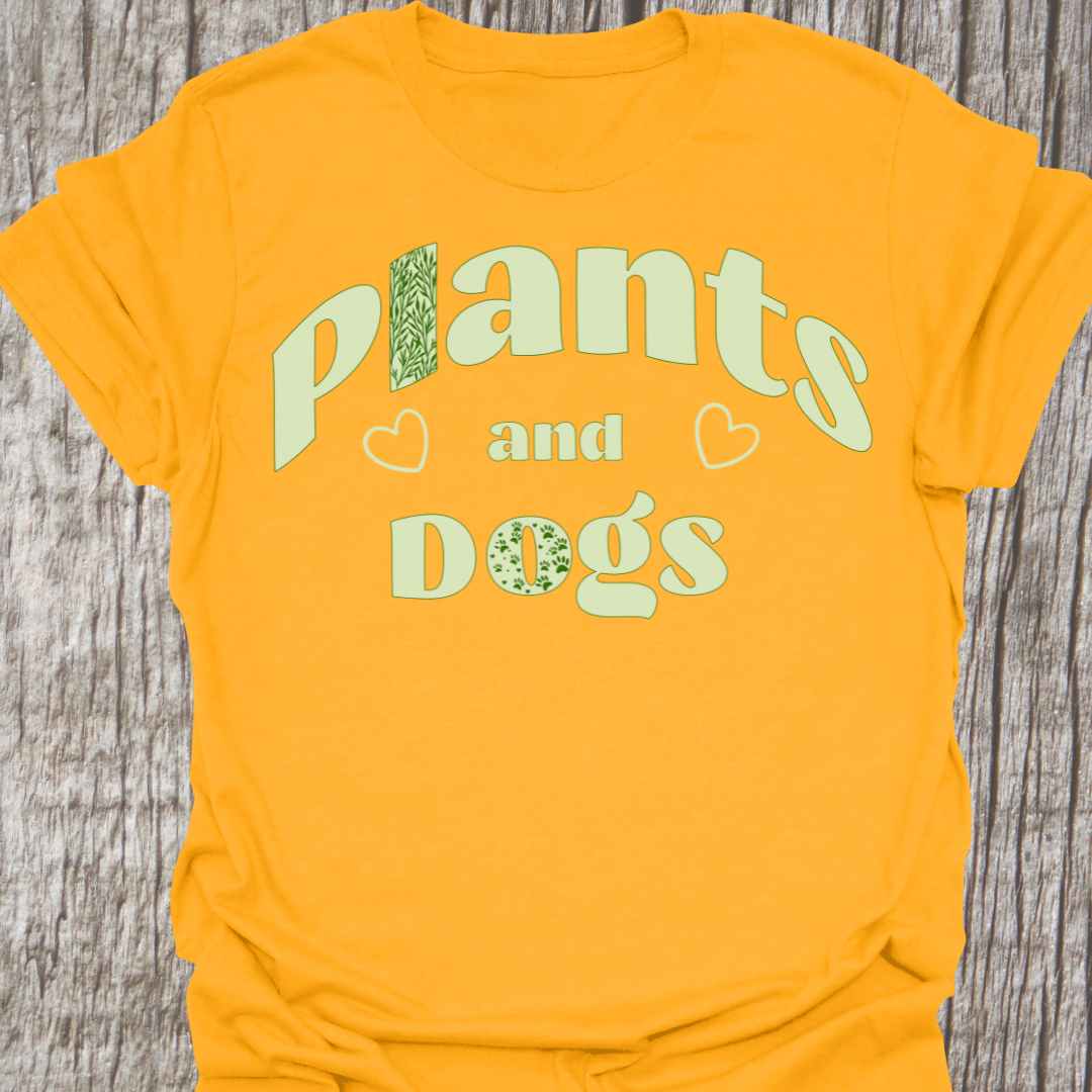 Plants and Dogs in text with subtle paw prints and leaves within the text design, decorated with two small hearts. Light green on a gold t-shirt