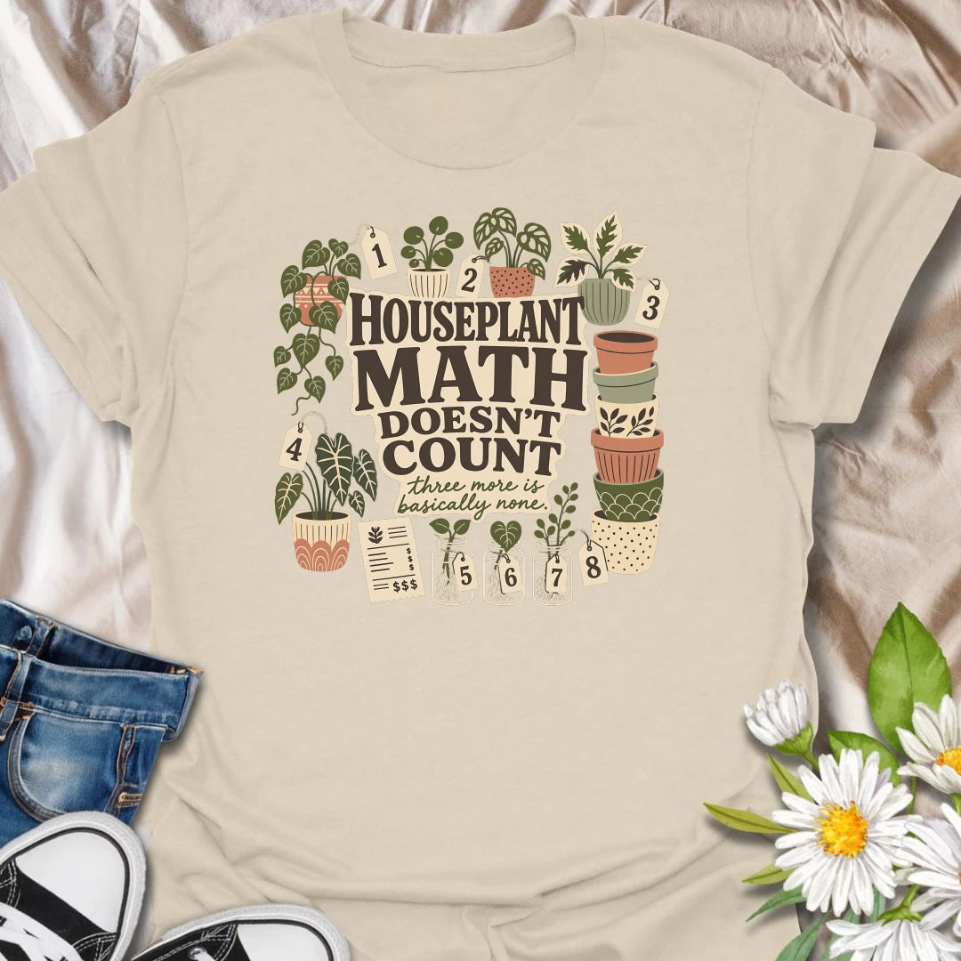 Plant numbers are always negotiable with this “Houseplant Math Doesn’t Count” T-shirt. Surrounded by numbered plants, decorative pots, cuttings, and a suspiciously long receipt, the design is perfect for enthusiastic indoor gardeners. It makes a funny gift for plant collectors who believe three more is basically none.