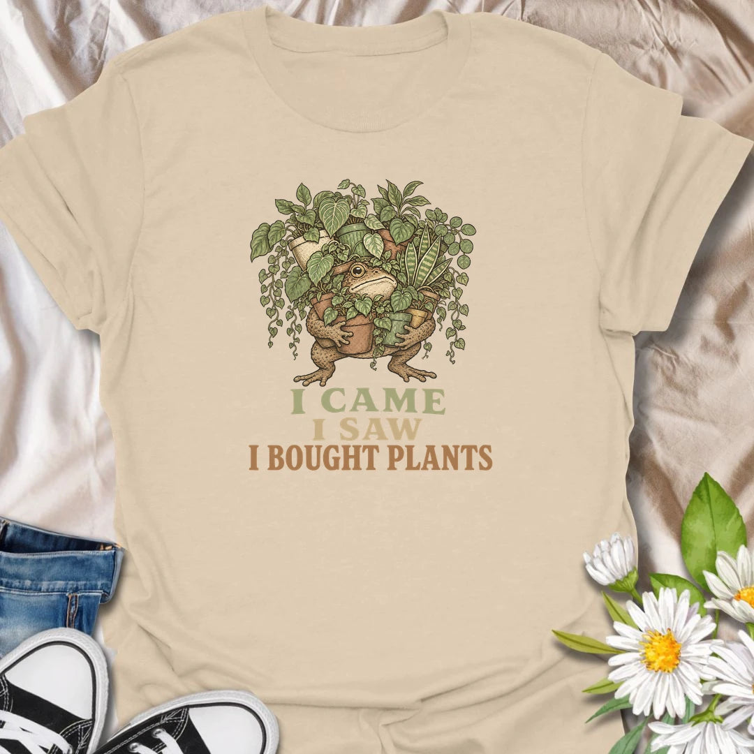 This I Came I Saw I Bought Plants t-shirt is perfect for plant lovers who never leave the nursery, garden center, or plant shop empty-handed. Featuring a determined frog carrying an armful of leafy houseplants, this funny botanical design is great for plant moms, plant dads, houseplant collectors, indoor gardeners, and anyone who always comes home with more plants.