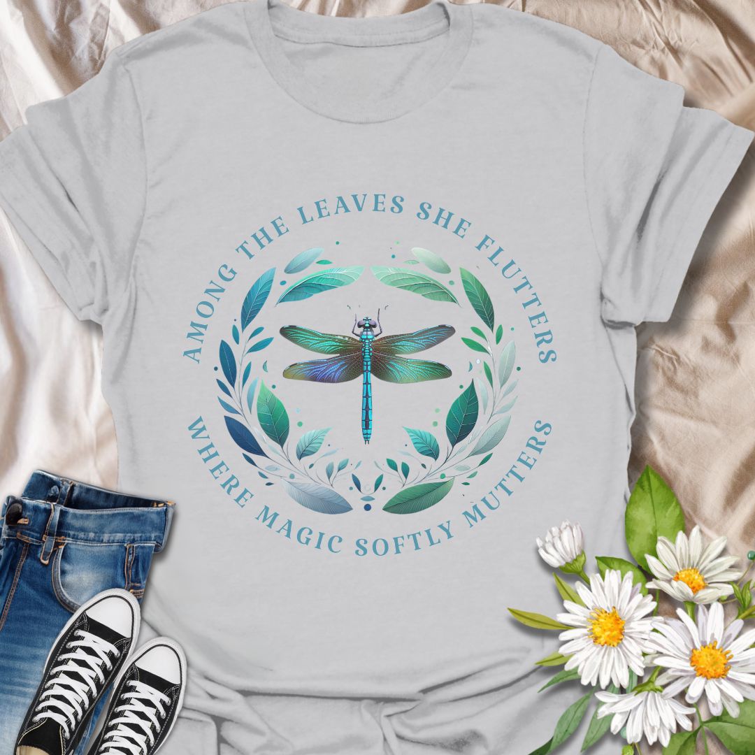 Mystical dragonfly t-shirt with detailed wings and a leafy circle, wrapped in the phrase “Among the leaves she flutters, where magic softly mutters.” A magical nature design for dreamers, woodland lovers, and poetic souls.