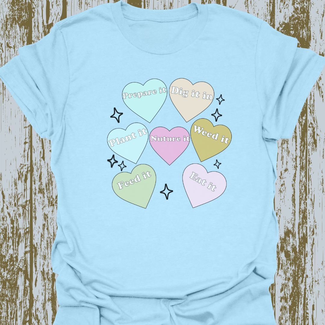 Hearts with plant-related text in pastel colors on a light blue T-shirt