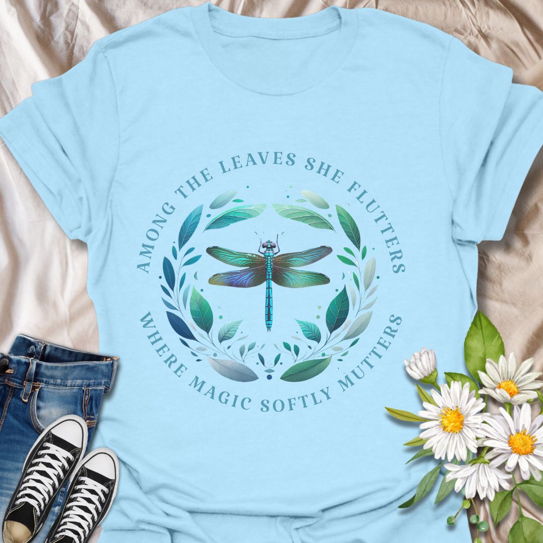 Mystical dragonfly t-shirt with detailed wings and a leafy circle, wrapped in the phrase “Among the leaves she flutters, where magic softly mutters.” A magical nature design for dreamers, woodland lovers, and poetic souls.