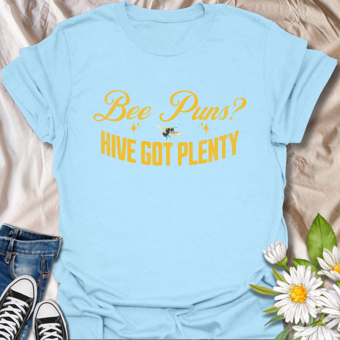 Funny "Bee Puns? Hive Got Plenty" t-shirt with vintage yellow typography and bee illustration on crisp white. Ideal for beekeepers, honey bee lovers, gardeners, pollinator supporters, and anyone who loves a clever bee pun. Great nature lover gift and perfect for eco-friendly fashion.