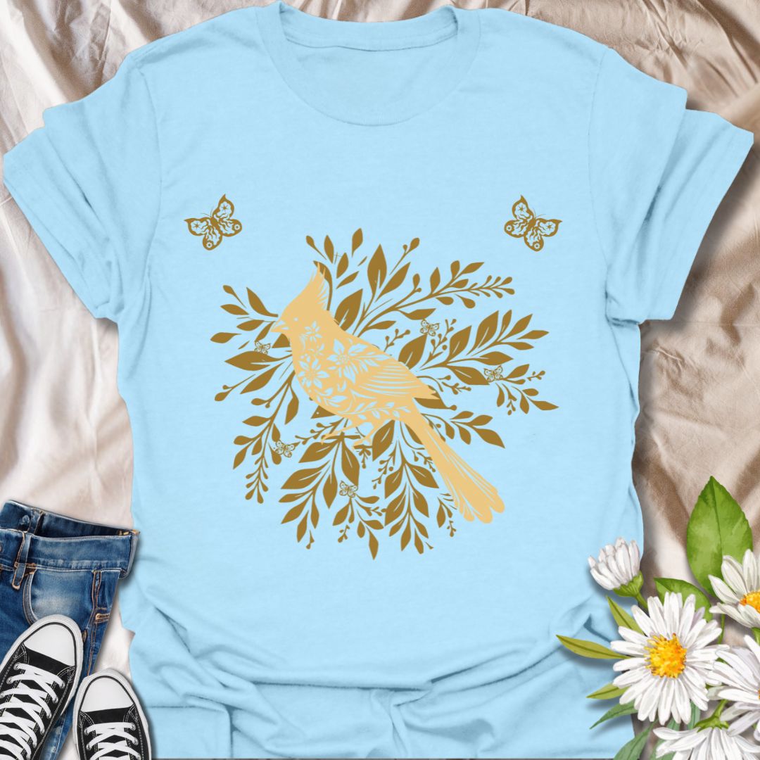 Charming bird and foliage t-shirt featuring a golden bird perched among stencil design botanical leaves. Perfect for bird lovers, nature fans, and botanical art enthusiasts. Light blue