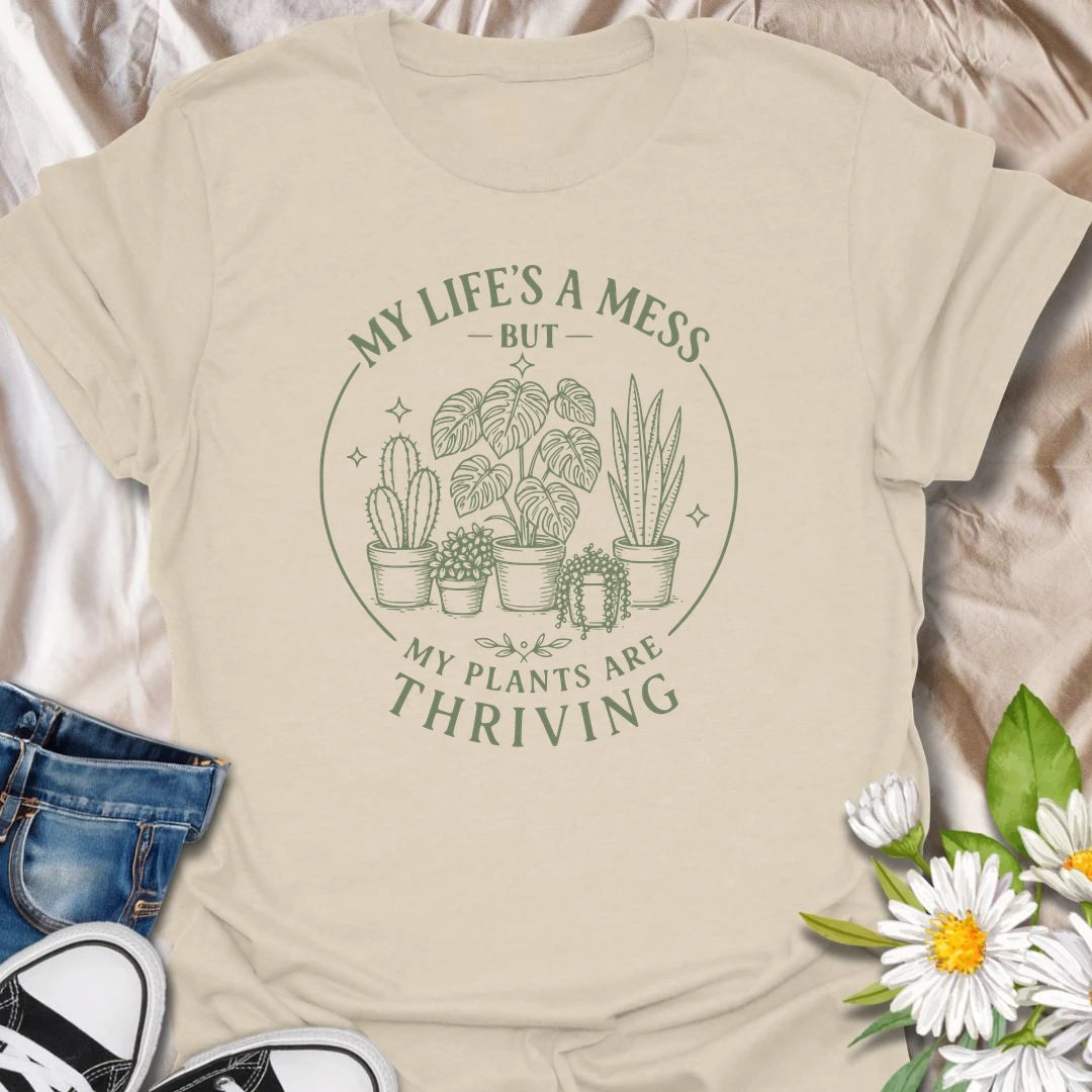 Plants Are Thriving t-shirt for anyone whose life may be messy, but whose houseplants are somehow doing beautifully.
The simple botanical line-art design gives the shirt a clean, relaxed look with relatable plant lover humor.
It is perfect for plant moms, indoor gardeners, houseplant collectors, and anyone who measures success by healthy leaves.
A funny gift for plant people who may not have everything together, but definitely have thriving plants.