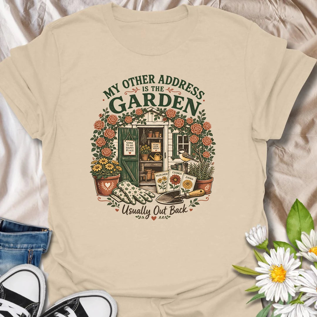Garden shed t-shirt for plant lovers who feel most at home outside among roses, seed packets, gloves, and garden tools.