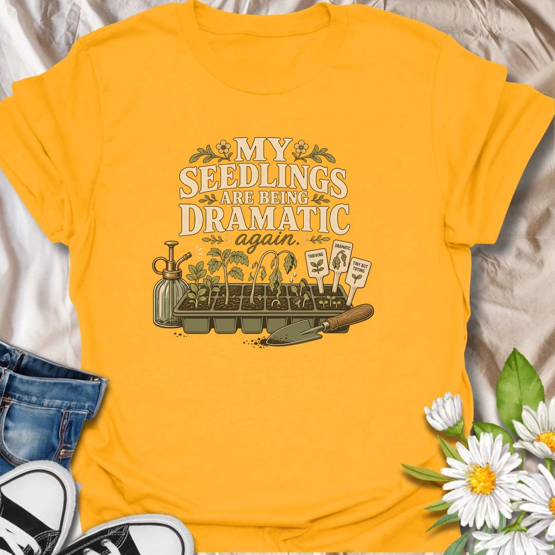 Seed-starting season comes with plenty of drama, and this funny gardening T-shirt understands. Featuring the phrase “My Seedlings Are Being Dramatic Again,” it includes wilted sprouts, plant markers, a mister, and a hand trowel. A perfect gift for vegetable gardeners and seed-starting enthusiasts.