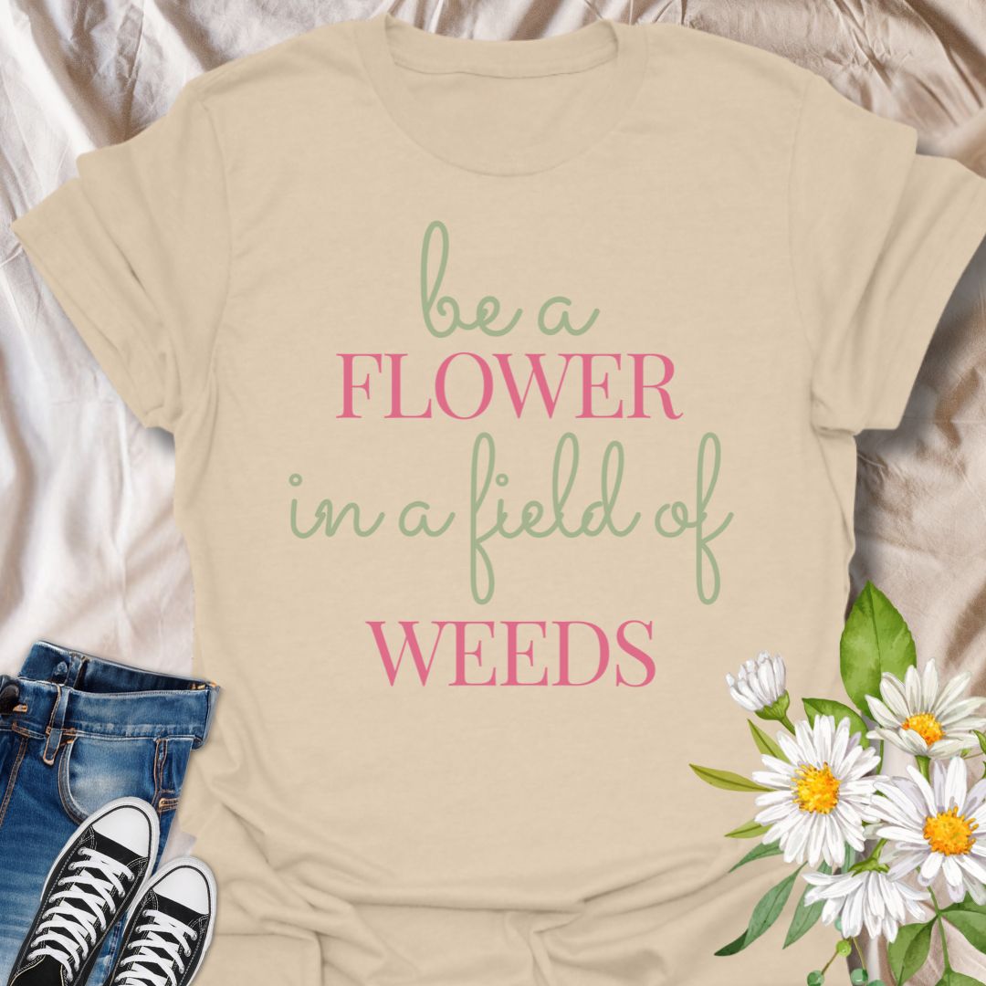 Stand out with this inspirational graphic t-shirt featuring the motivational phrase "Be a Flower in a Field of Weeds." Perfect for positivity seekers, nature lovers, and anyone who enjoys uplifting, floral-themed apparel with a meaningful message.