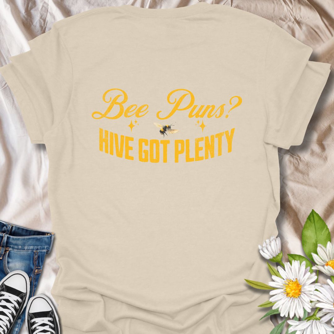 Funny "Bee Puns? Hive Got Plenty" t-shirt with vintage yellow typography and bee illustration on crisp white. Ideal for beekeepers, honey bee lovers, gardeners, pollinator supporters, and anyone who loves a clever bee pun. Great nature lover gift and perfect for eco-friendly fashion.