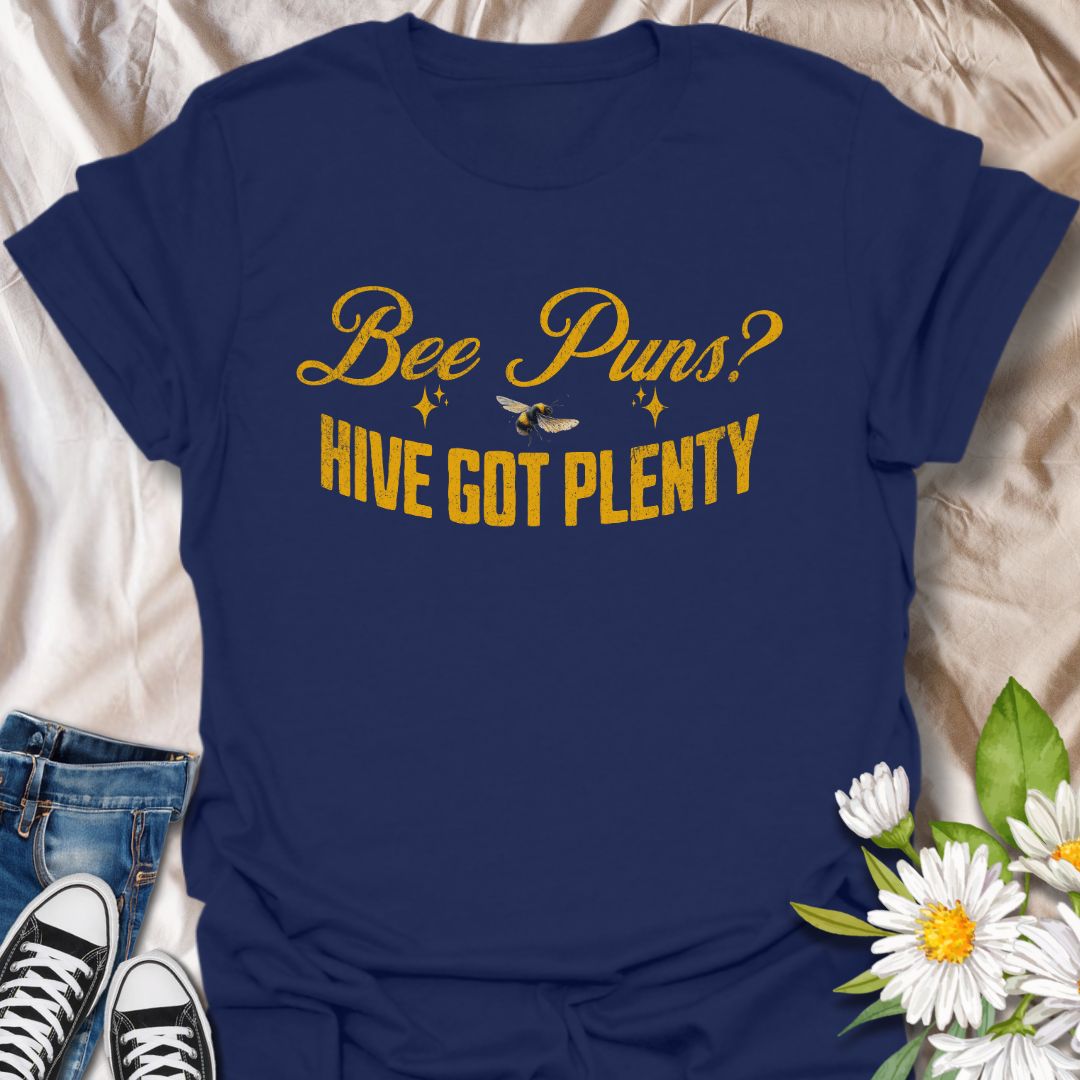 Funny "Bee Puns? Hive Got Plenty" t-shirt with vintage yellow typography and bee illustration on crisp white. Ideal for beekeepers, honey bee lovers, gardeners, pollinator supporters, and anyone who loves a clever bee pun. Great nature lover gift and perfect for eco-friendly fashion.