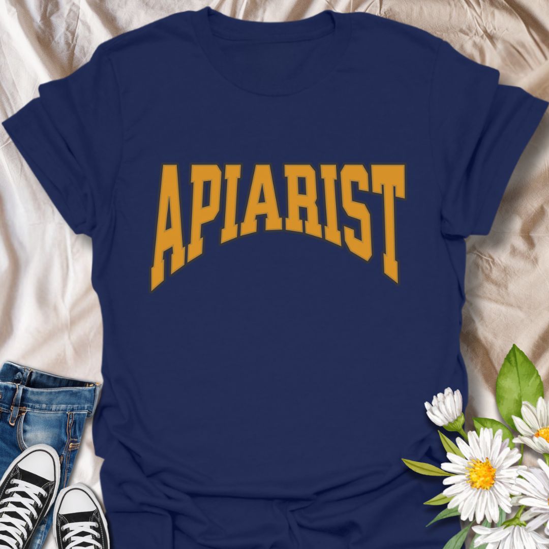 Simple bold "Apiarist" t-shirt with collegiate-style yellow lettering on black. Perfect for professional beekeepers, hobbyist beekeepers, honey producers, and bee conservation advocates. Great gift for anyone passionate about apiculture, bee science, or protecting pollinators.