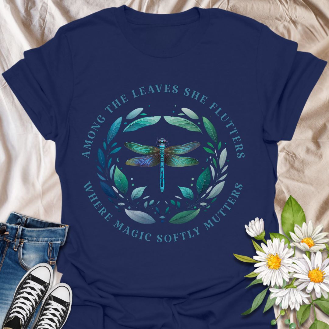 Mystical dragonfly t-shirt with detailed wings and a leafy circle, wrapped in the phrase “Among the leaves she flutters, where magic softly mutters.” A magical nature design for dreamers, woodland lovers, and poetic souls.